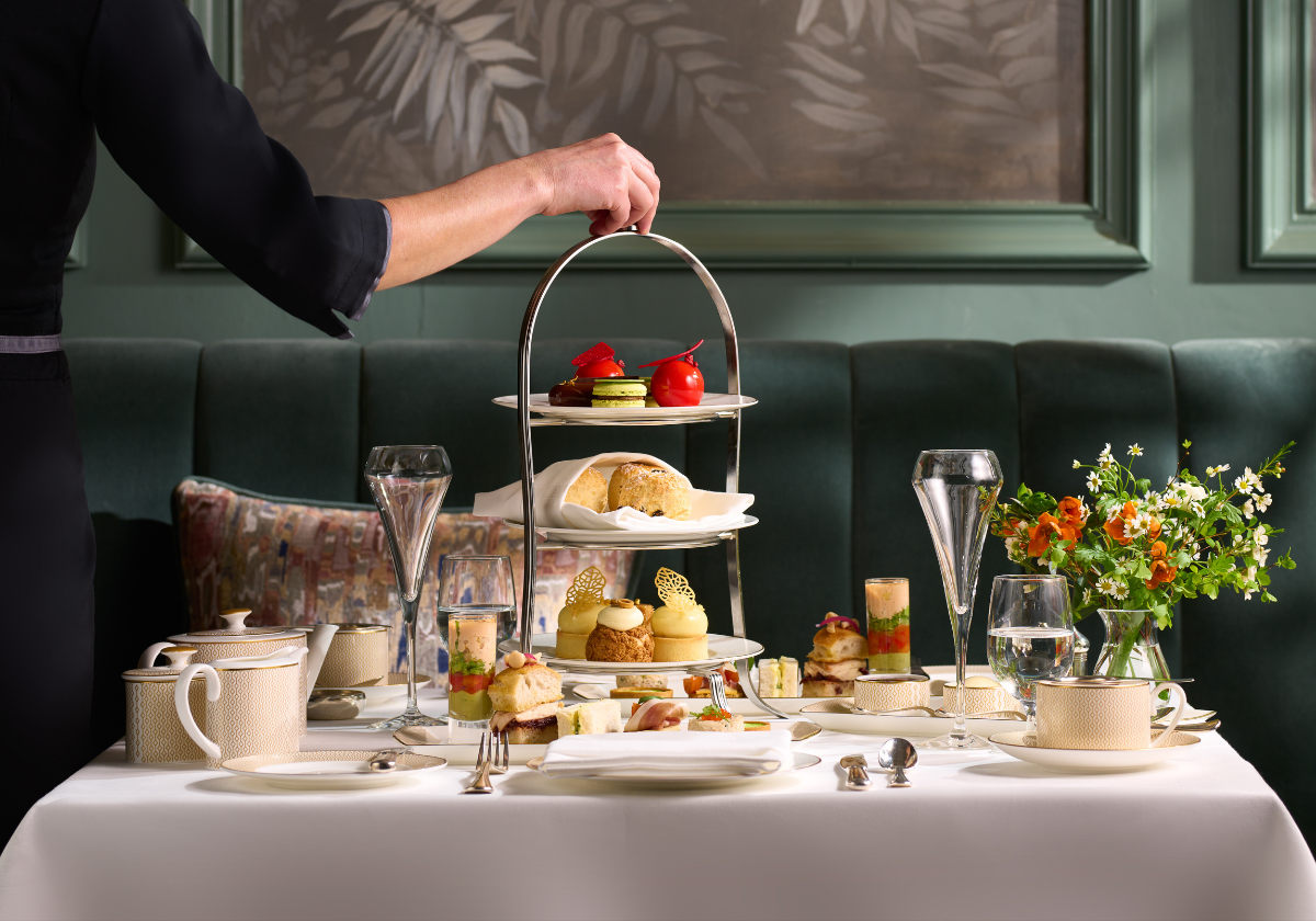 Afternoon Tea Service at featuring an assortment of mini pastries, finger sandwiches and scones elegantly presented.