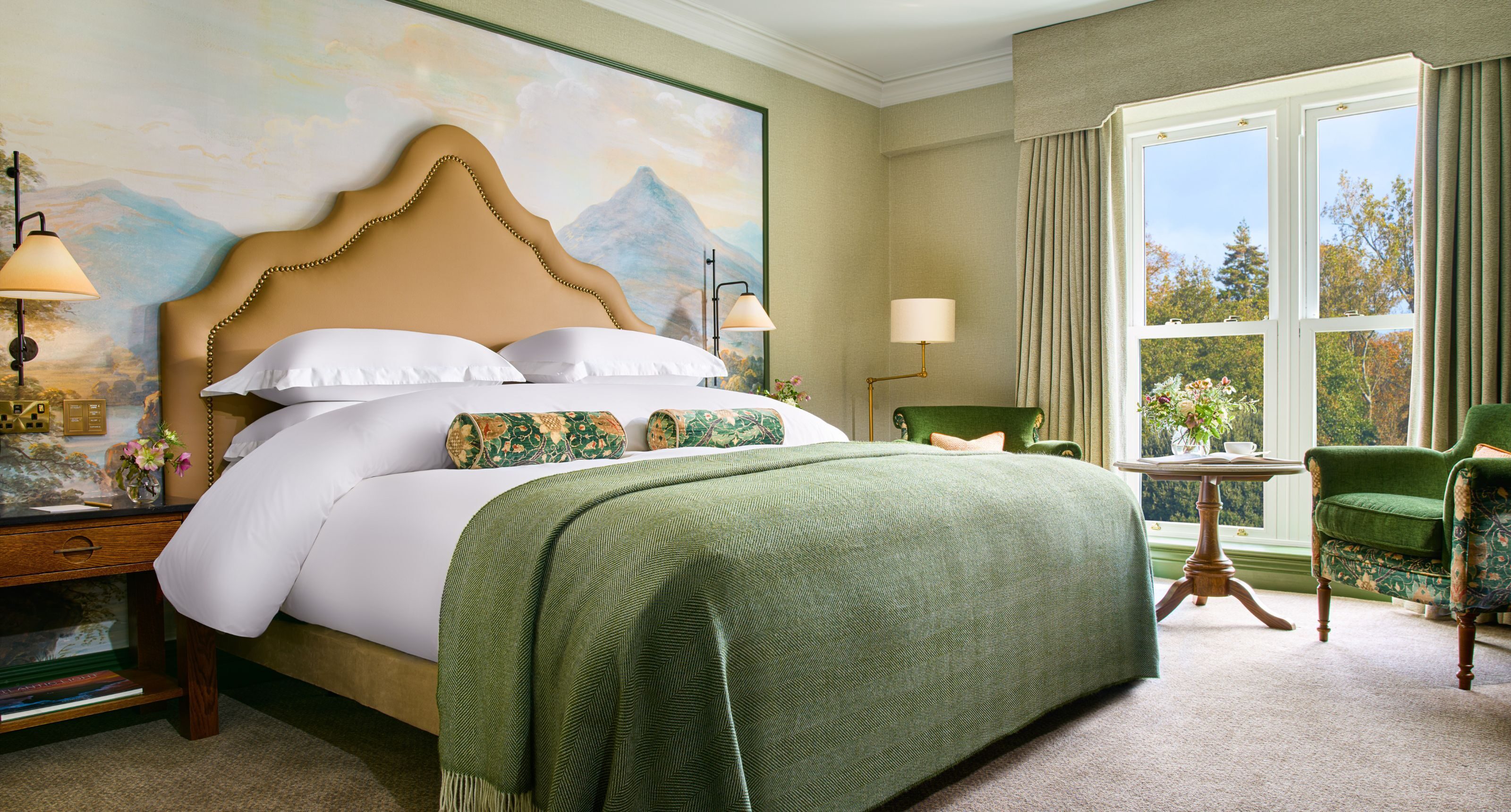 Elegant guest room showcasing a comfortable king bed, garden view and artistic wallpaper reflecting the charm of Killarney.