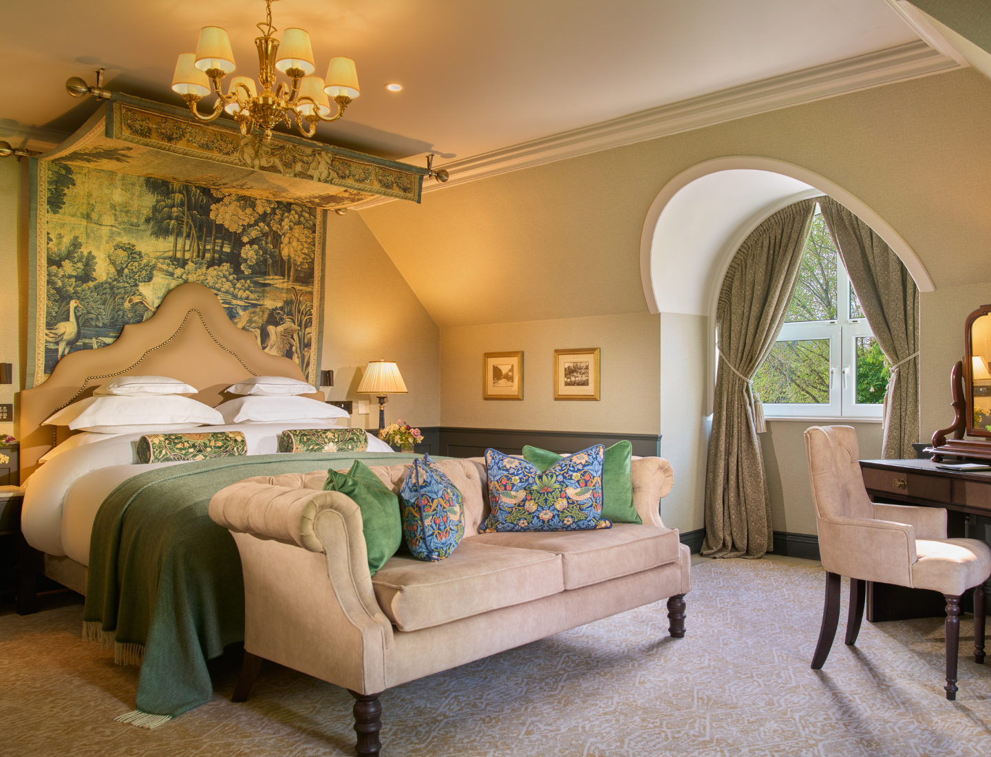 Elegant and Luxurious Muckross Suite featuring cosy chair and couch and warm ambient lighting.