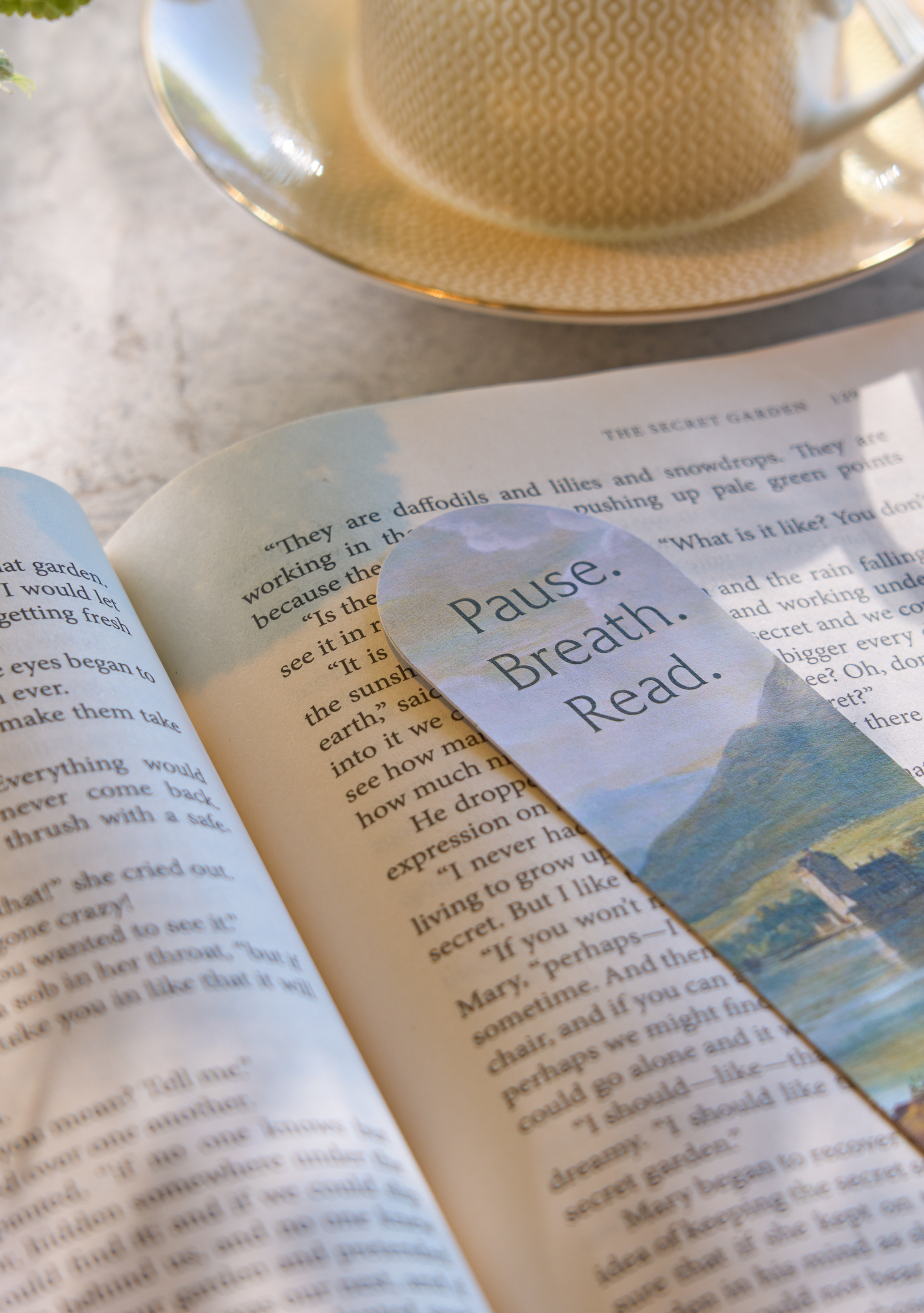A guest spending their time relaxing while sipping a hot cup of tea and reading a book.