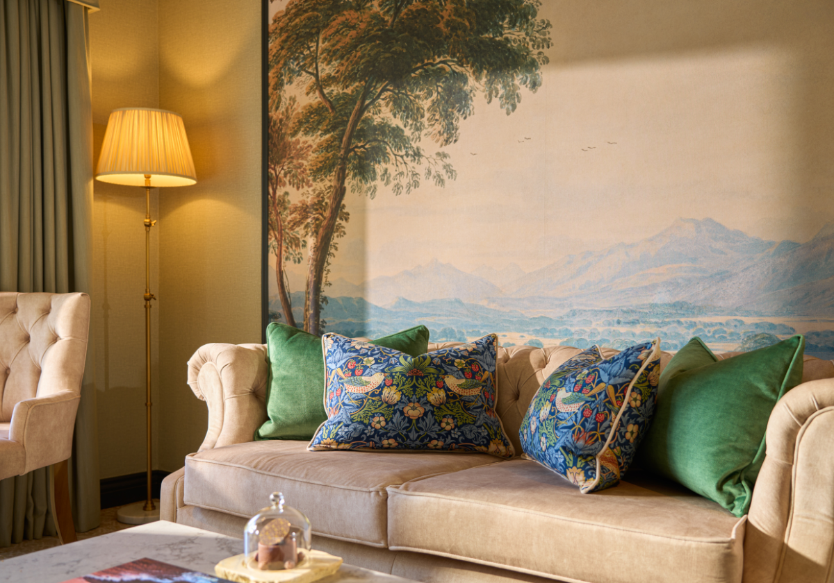Cosy beige couch with a scenic background in the Guest Suite