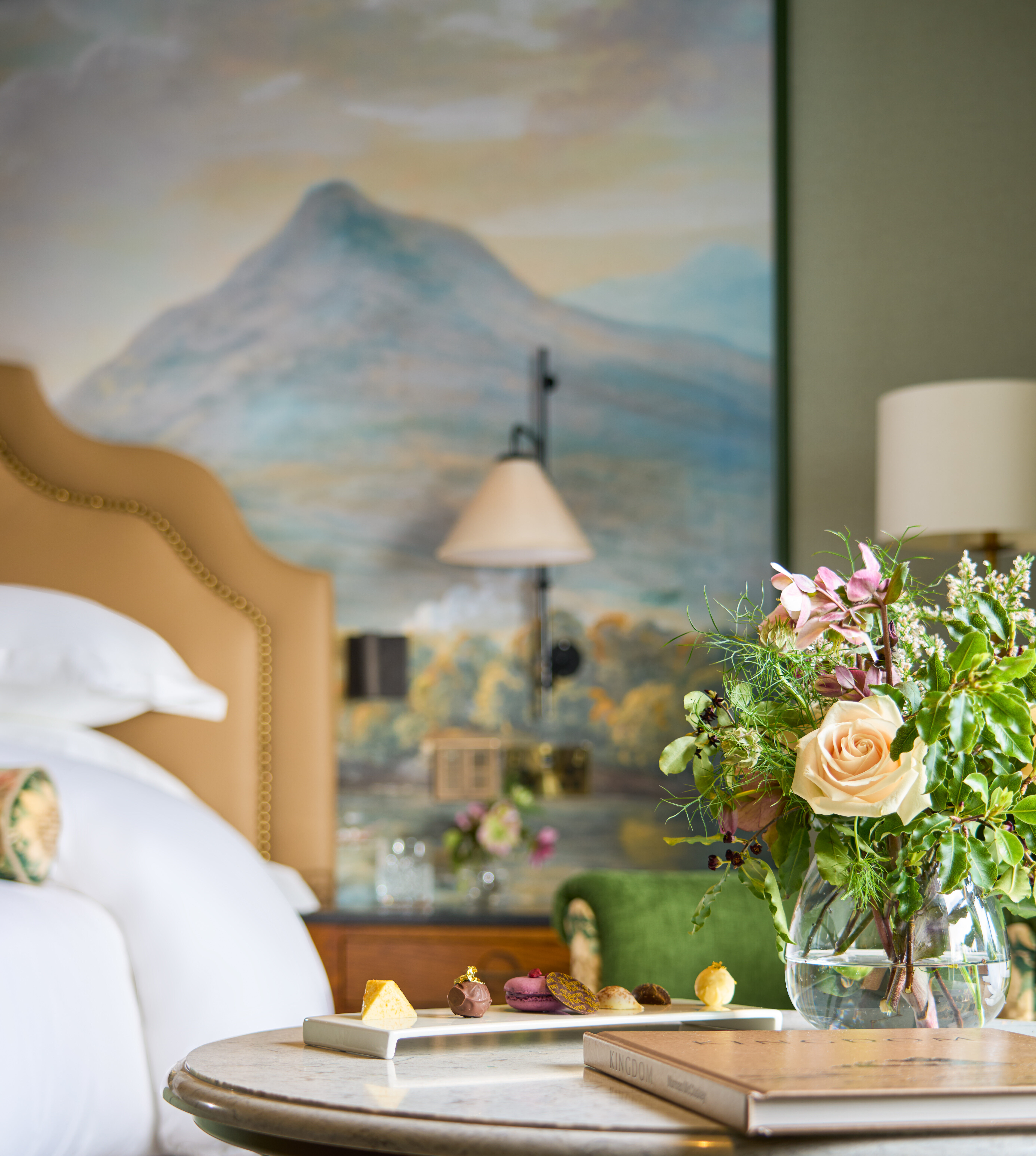 Mural detail in the background and guest room amenity- selection of small pastries.