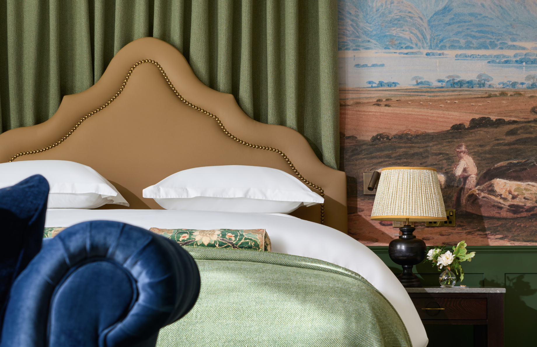 Closer view of the King Bed and bedside table. with a beautiful background wallpaper of Kerry
