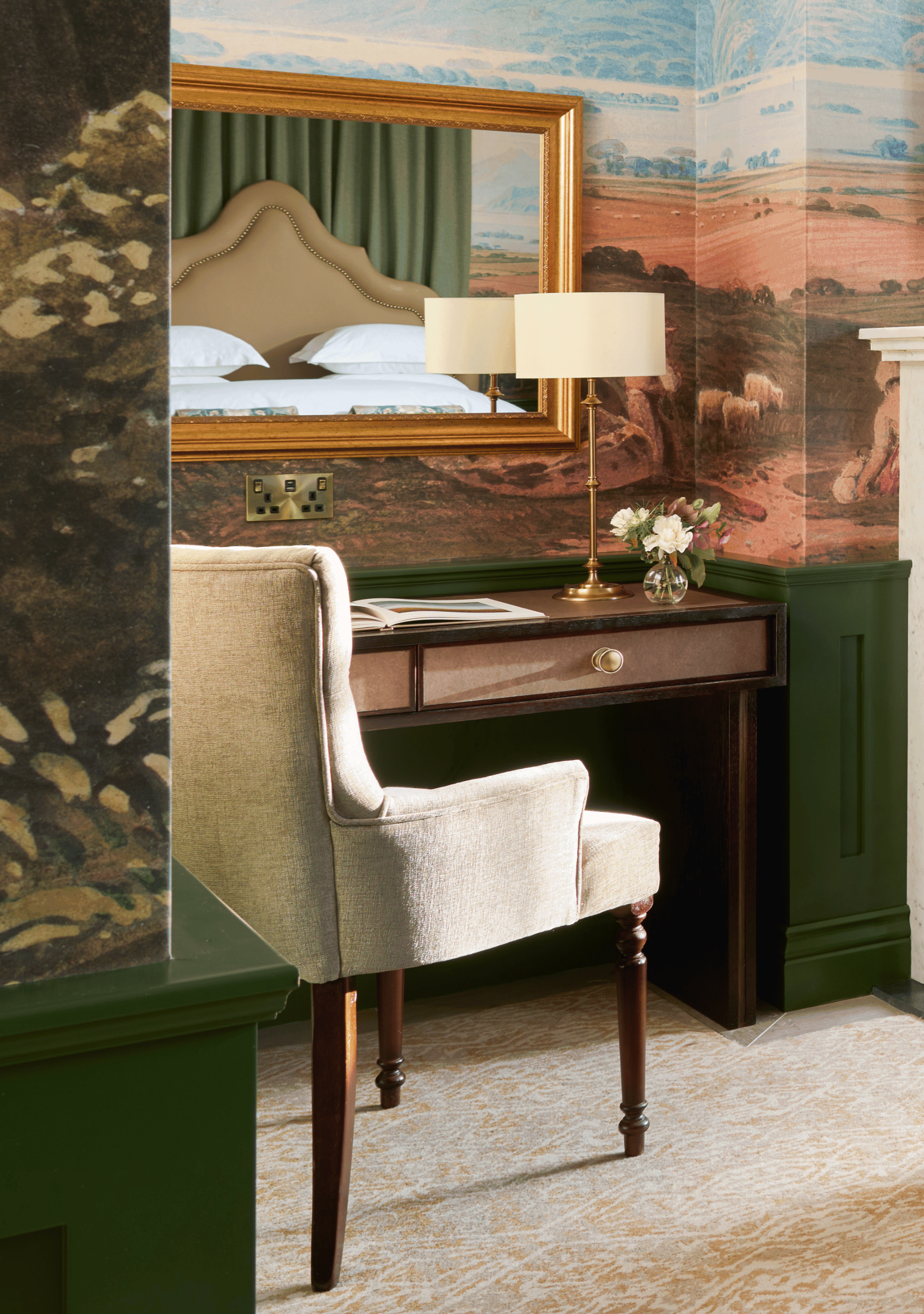 comfortable armrest chair and a writing desk in The Signature Suite.