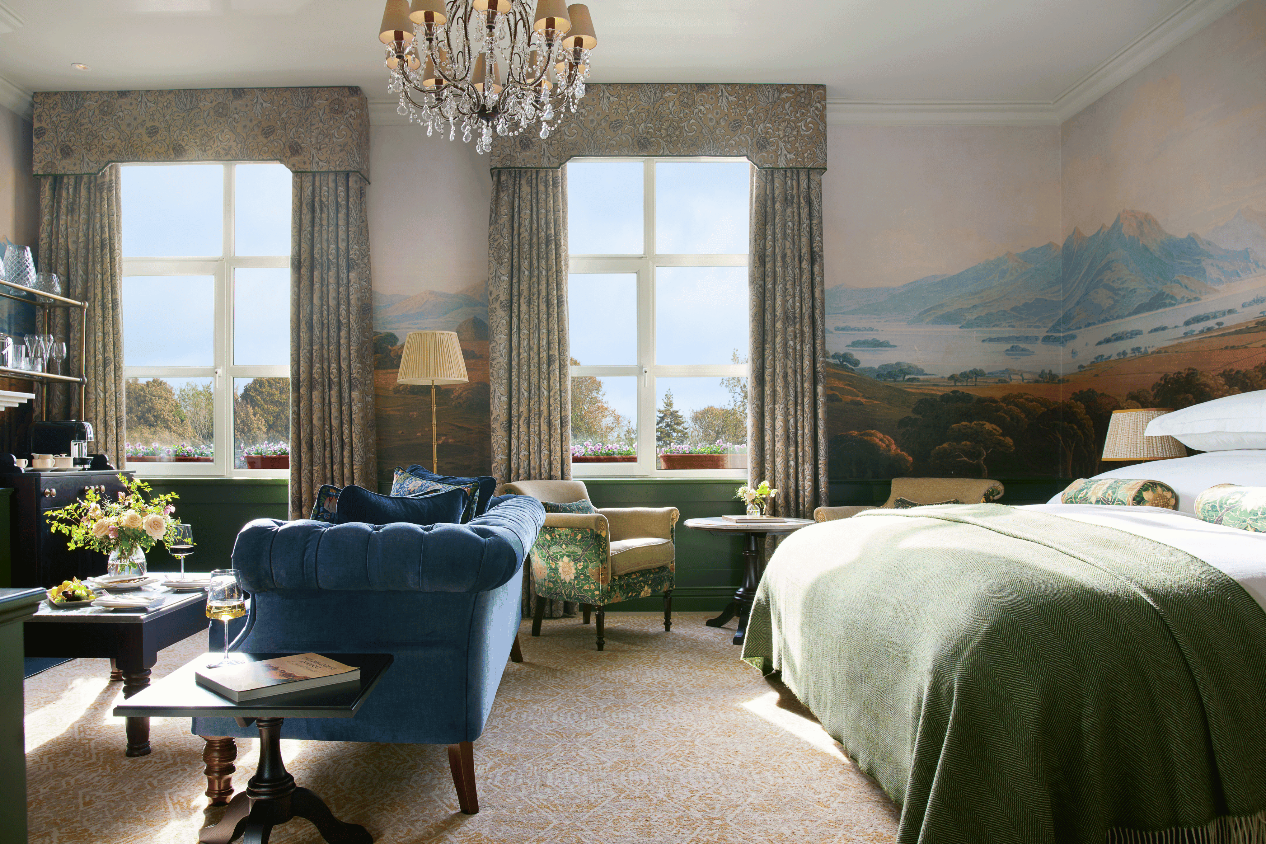 the view when you enter the Signature Suite, a king-size bed, comfortable couch, a chandelier and two big windows.