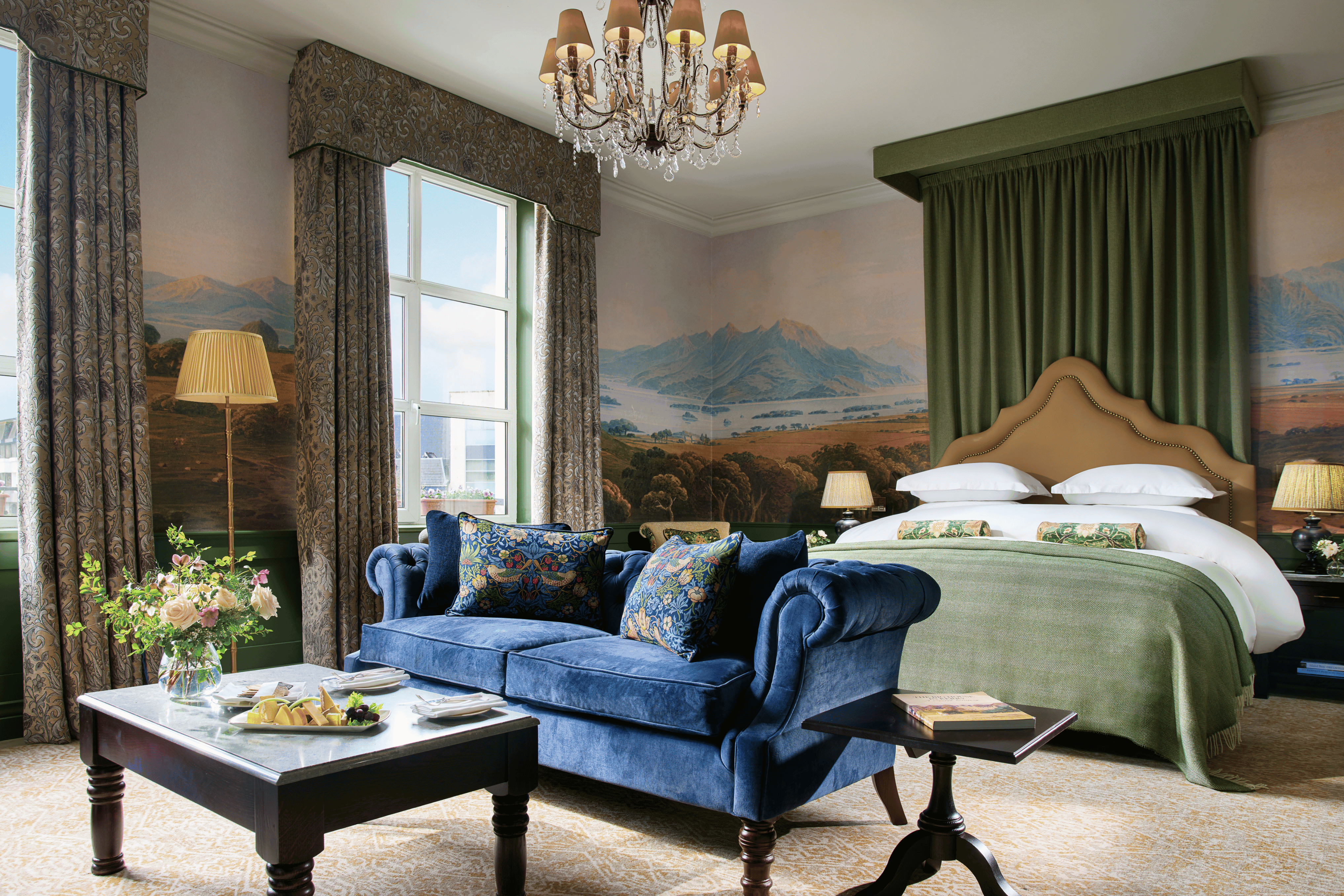 This is the Signature Suite; a blue couch Infront of the king-size bed.