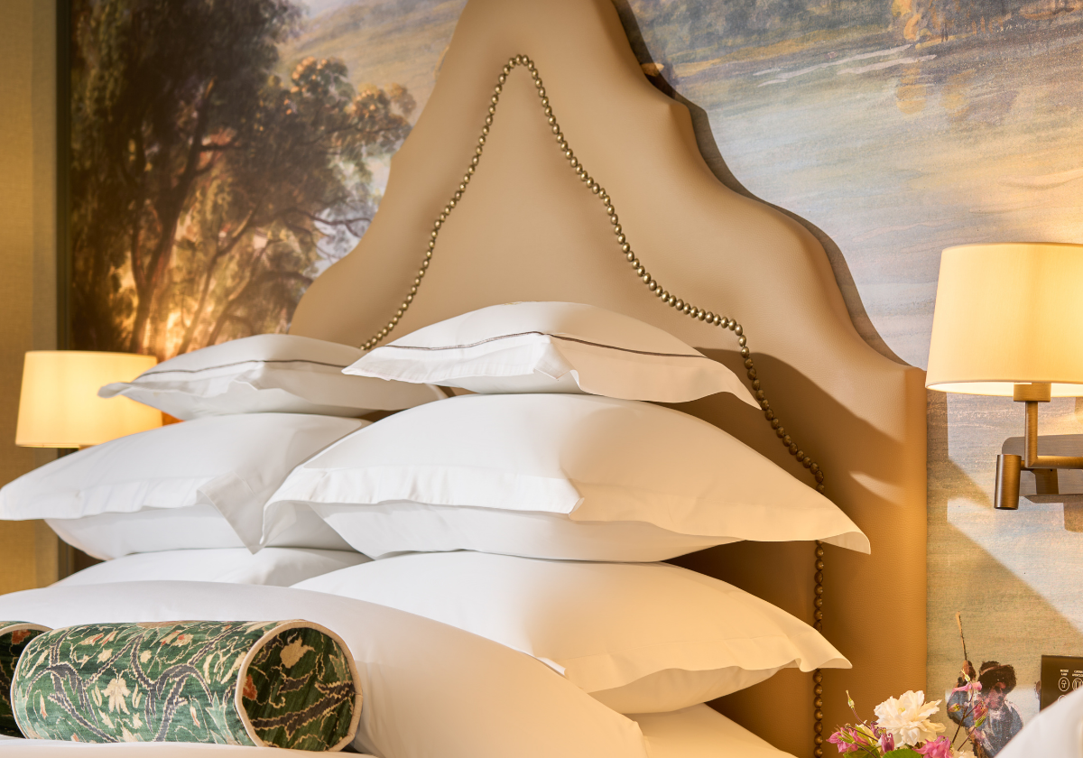 A stack of pillows on the king bed.