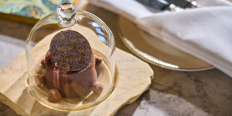 A guest receiving a Welcome Cake as one of their amenities